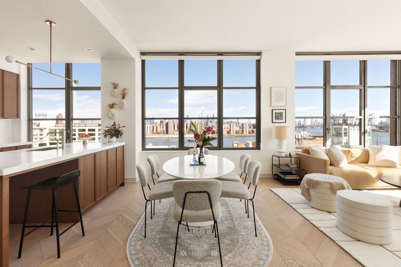 Open living and dining room with skyline windows at 180 Front Street 11E, DUMBO