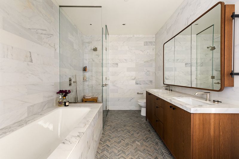 Marble primary bath with soaking tub at 180 Front Street 11E, DUMBO — photo 7 of 9