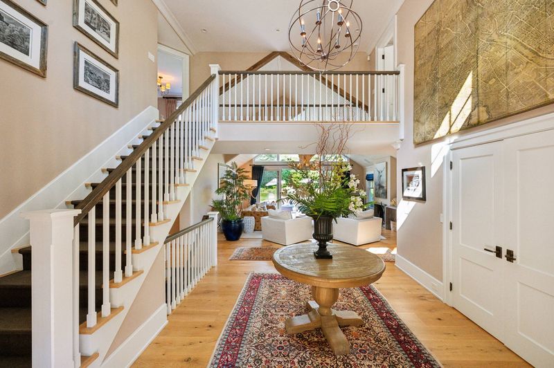 Two-story foyer and stair at 2 Borden Lane, East Hampton — photo 5 of 12