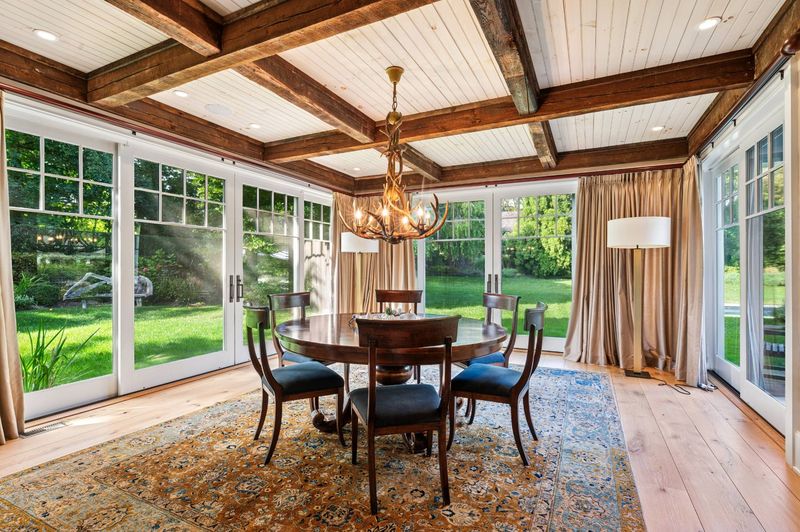 Formal dining with walls of glass at 2 Borden Lane, East Hampton — photo 8 of 12