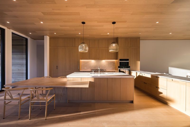 Kitchen and dining under a wood ceiling at 204 Head of Pond Road, Water Mill — photo 5 of 10