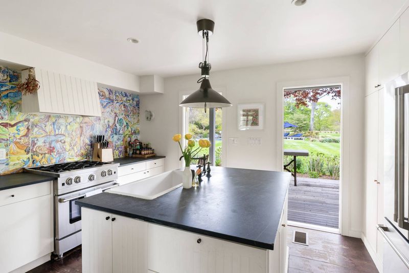 Kitchen range wall and island at 216 Sagaponack Road, Bridgehampton — photo 11 of 12