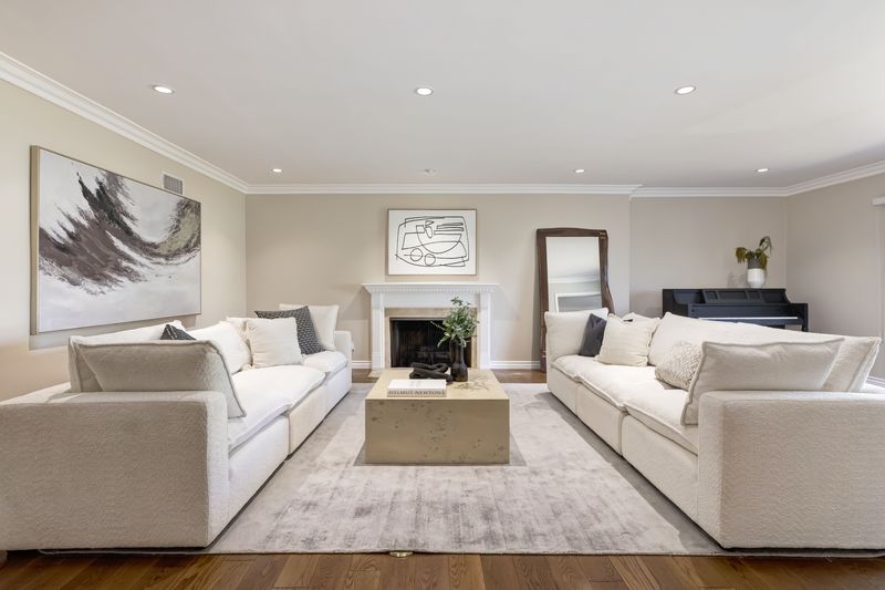 Symmetrical living room with facing sofas and fireplace at 2302 Duxbury Circle, Beverlywood — photo 3 of 8