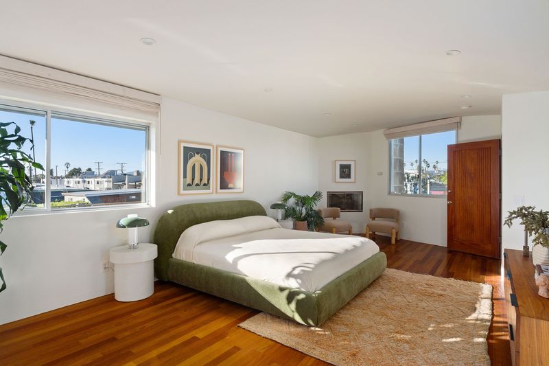 Bedroom with warm wood floors and garden views at 2324 Boone Avenue, Venice — photo 6 of 8
