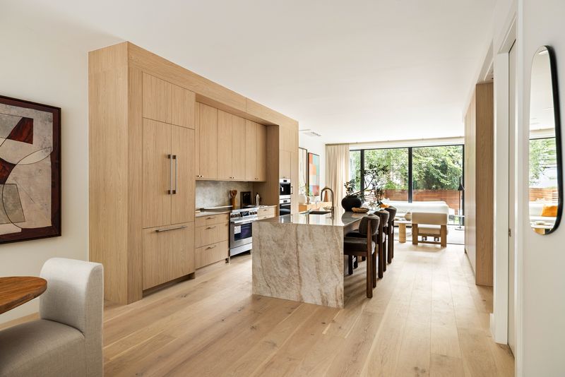 Open living/dining/kitchen floor with floor-to-ceiling glass to the garden at 235 Sackett Street #1, Carroll Gardens
