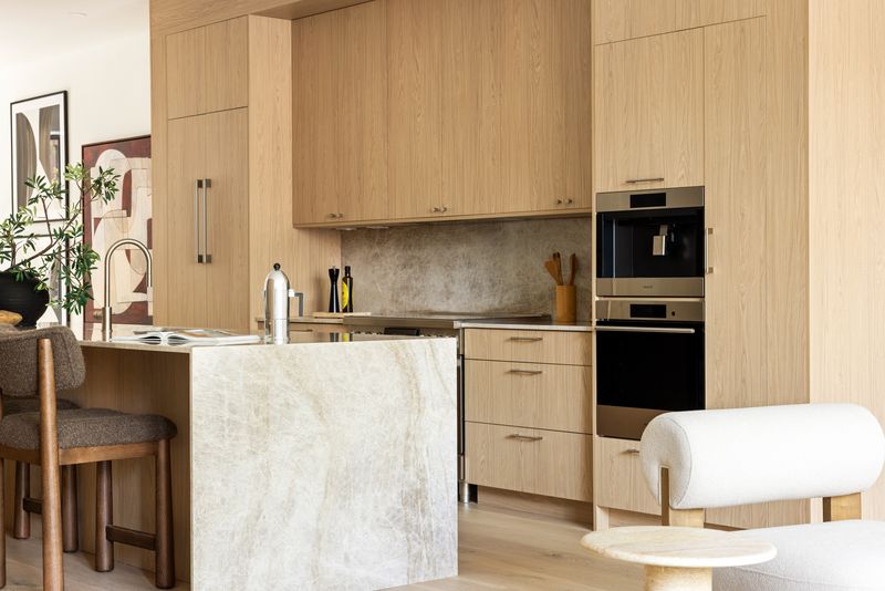 Kitchen island in marble with oak cabinetry at 235 Sackett Street #1, Carroll Gardens — photo 5 of 12