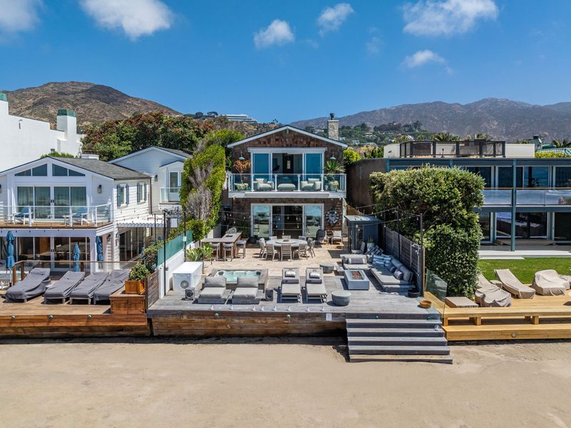 The beach house seen from the sand at 23812 Malibu Road, Malibu