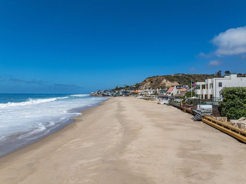 Sandy beach curving west along Malibu Road at 23812 Malibu Road, Malibu — photo 3 of 8