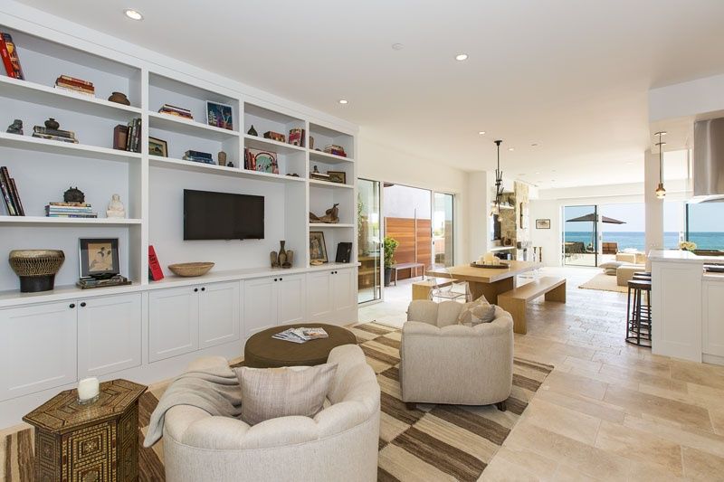 Living room with white built-in shelving at 23812 Malibu Road, Malibu — photo 5 of 8