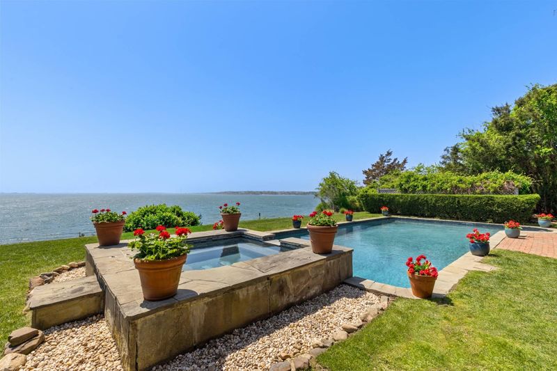 Pool and hot tub at the top of the bluff, looking out over the bay at 24 Aqua Drive, Southampton — photo 3 of 11