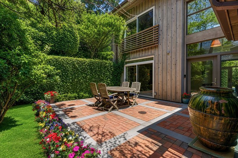 Brick patio and garden beside the house at 24 Aqua Drive, Southampton — photo 11 of 11