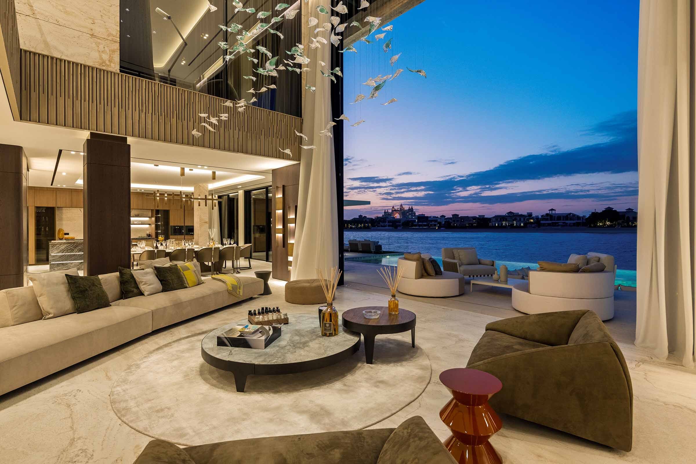 twilight living room opening to the pool at the 25 Degrees Signature Villa