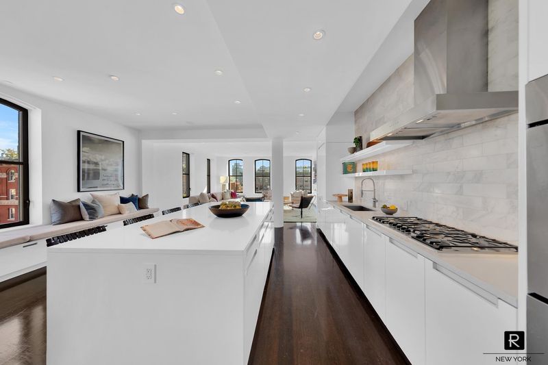 Oversized kitchen with long island and marble backsplash at 250 West Street 9JK, Tribeca — photo 2 of 12