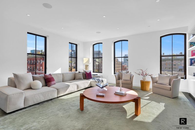 Great room seating area under a wall of arched windows at 250 West Street 9JK, Tribeca — photo 3 of 12