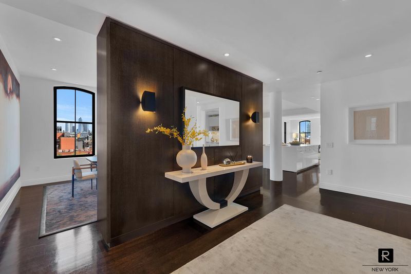 Grand foyer and gallery with walnut feature wall at 250 West Street 9JK, Tribeca — photo 4 of 12