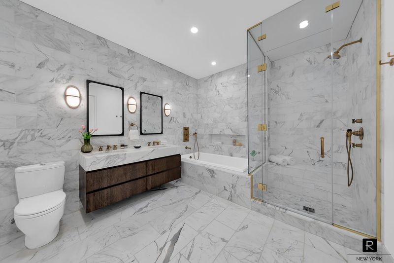 Primary bath in marble with glass shower and soaking tub at 250 West Street 9JK, Tribeca — photo 7 of 12
