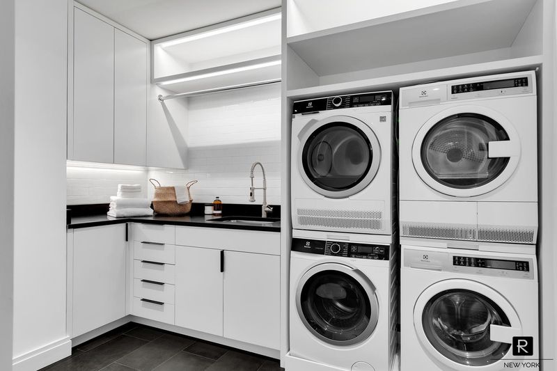 Laundry room with double Electrolux washer/dryer at 250 West Street 9JK, Tribeca — photo 11 of 12