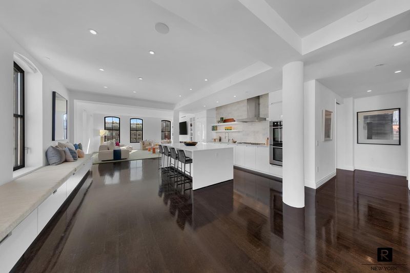 Great room view from the gallery toward the kitchen and living area at 250 West Street 9JK, Tribeca — photo 12 of 12