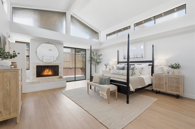 Primary bedroom with fireplace and patio door at 2516 The Strand, Manhattan Beach — photo 5 of 8