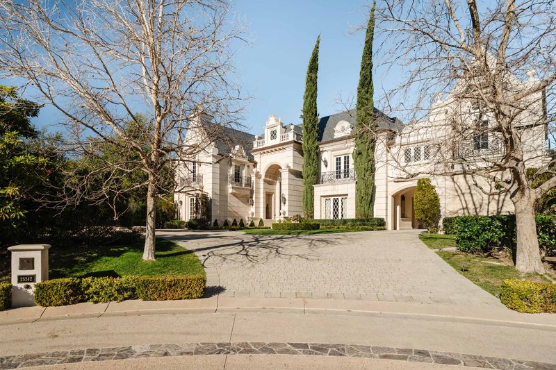 Stone French Country facade and motor court at 25242 Prado Del Misterio, Calabasas