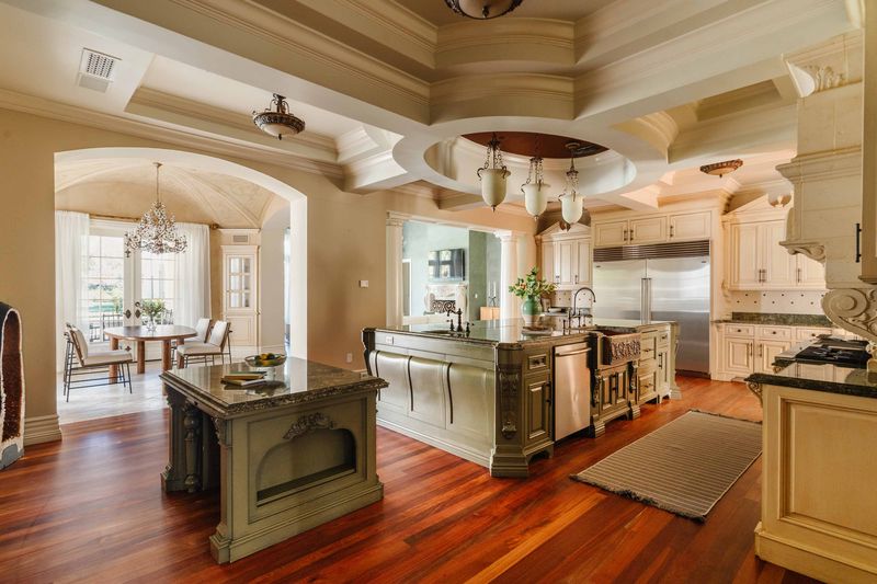 Kitchen and living volume under coffered ceiling at 25242 Prado Del Misterio, Calabasas — photo 8 of 8