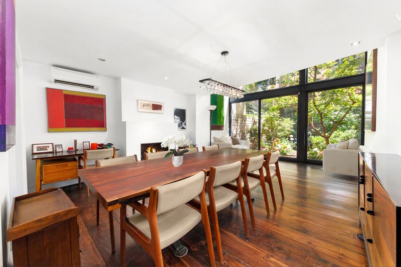 Double-height living and dining room with glass wall at 264 West 12th Street, West Village
