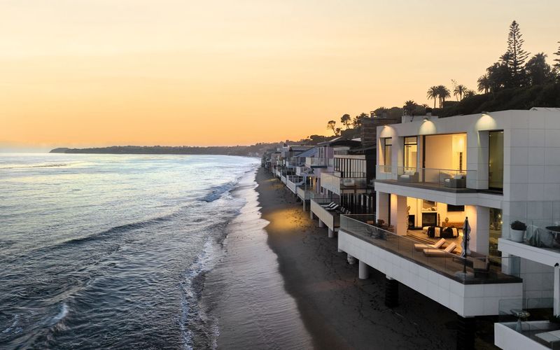 Lit terraces on the sand at sunset at 26814 Malibu Cove Colony Drive, Malibu