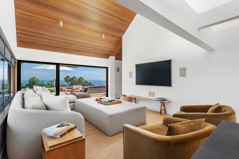 Living room under a vaulted wood ceiling with ocean view at 27553 Pacific Coast Highway, Malibu — photo 2 of 6