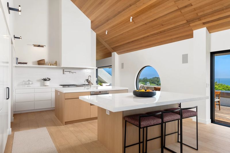 Kitchen islands with porthole window at 27553 Pacific Coast Highway, Malibu — photo 4 of 6
