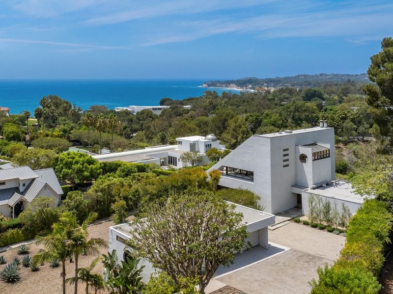 Aerial view of the house and coastline toward Point Dume at 27553 Pacific Coast Highway, Malibu — photo 6 of 6