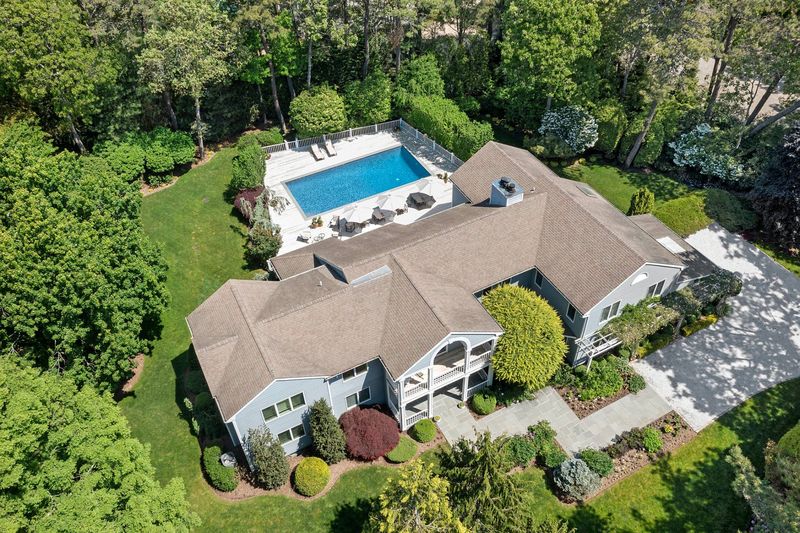 Aerial of house, pool and acre at 3 Acorn Path, Quogue — photo 3 of 9
