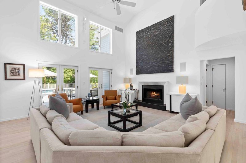 Living room vaulted ceiling and fireplace at 3 Acorn Path, Quogue — photo 5 of 9