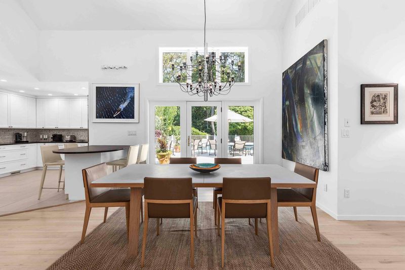 Dining open to kitchen at 3 Acorn Path, Quogue — photo 6 of 9