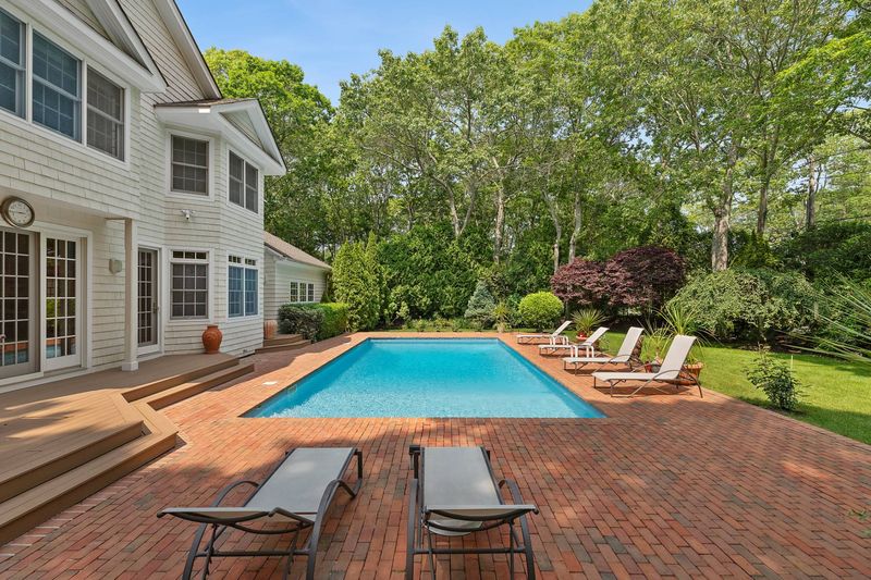 Heated pool, brick deck and lawn at 3 Whitney Lane, Wainscott