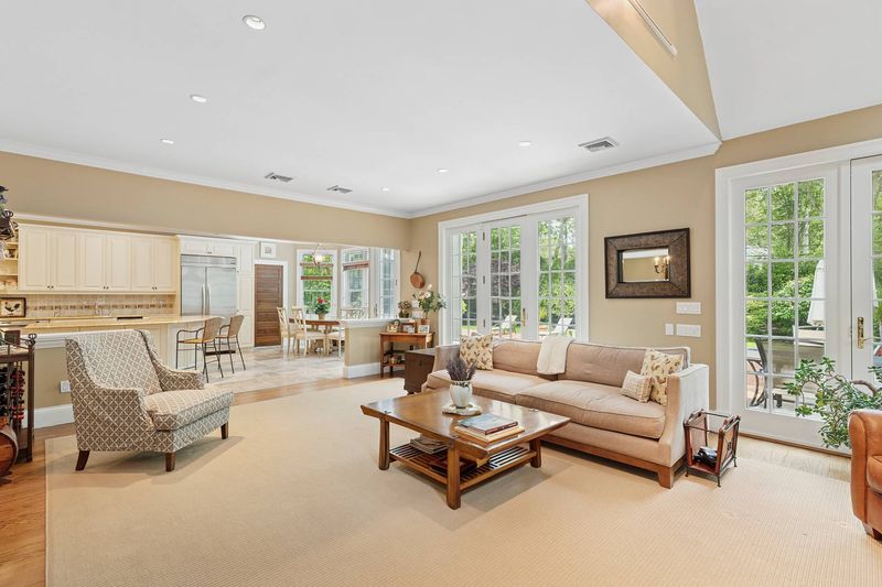 Great room to kitchen and deck at 3 Whitney Lane, Wainscott — photo 3 of 8