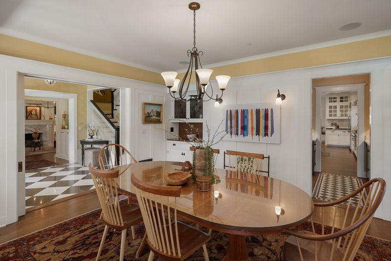 The formal dining room under a period chandelier, with views through to the entry hall at 303 Markham Place, Pasadena — photo 4 of 12
