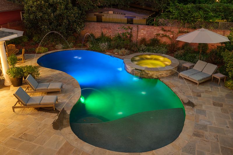 The pool and spa lit up at dusk at 303 Markham Place, Pasadena — photo 8 of 12