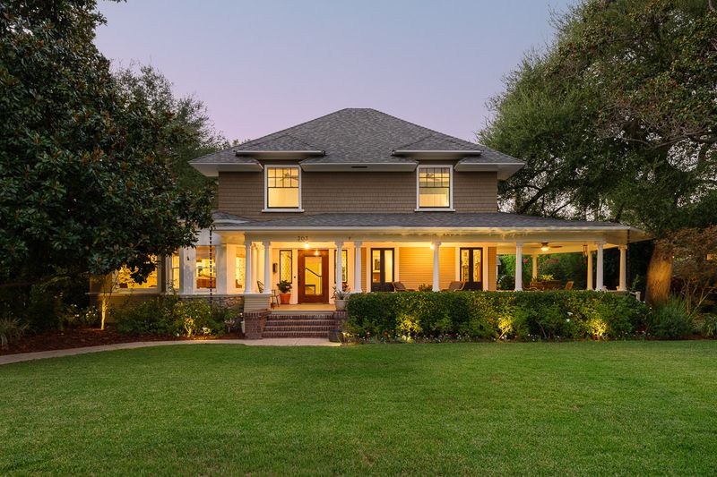 The front of the house glowing at twilight across the lawn at 303 Markham Place, Pasadena — photo 9 of 12