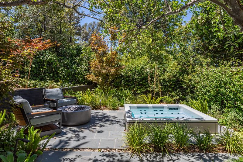 A spa set into the landscaped garden, with lounge seating alongside at 3101 Fryman Road, Studio City — photo 8 of 12
