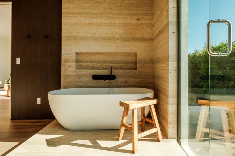 Primary bath with a sculptural pedestal tub at 317 South Wetherly Drive, Beverly Hills — photo 9 of 9