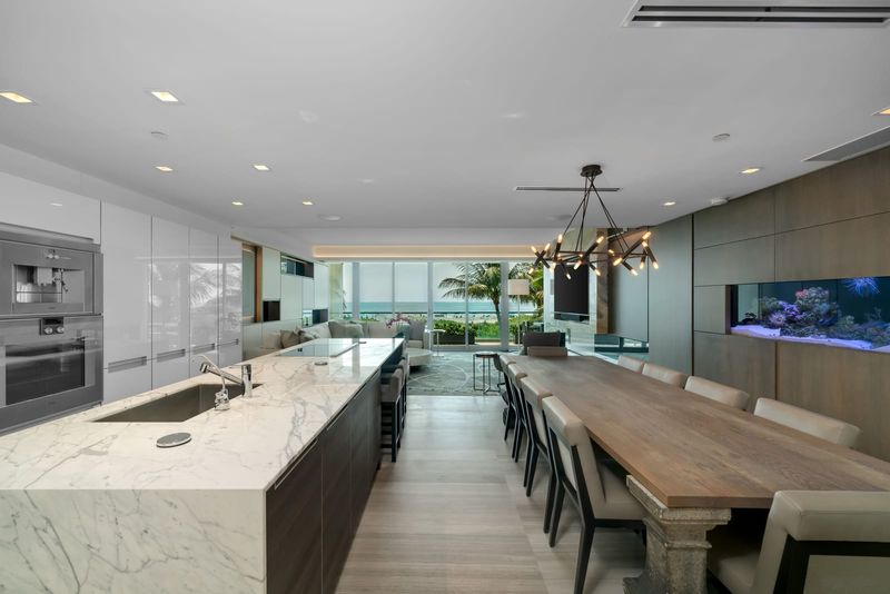 Marble kitchen opening to the dining area at Beach House 200, 321 Ocean Drive, Miami Beach — photo 4 of 8