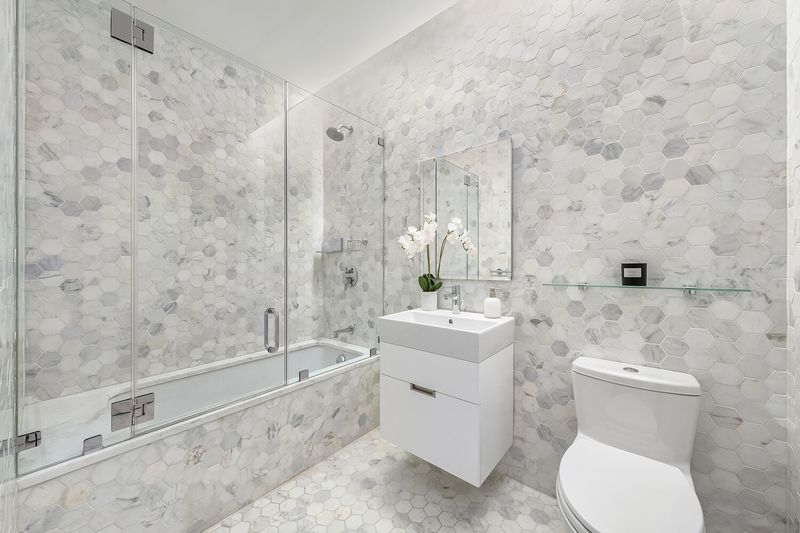 Bath with tub and marble tile at 325 West Broadway 7B, SoHo — photo 10 of 13