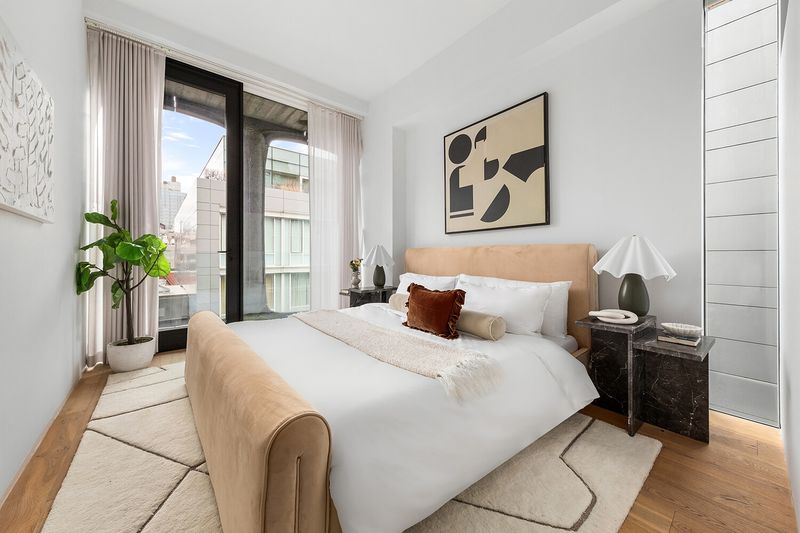 Bedroom with upholstered bed at 325 West Broadway 7B, SoHo — photo 11 of 13