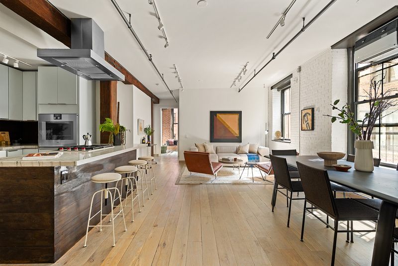 Open loft with timber beams, kitchen and dining at 33 Bleecker Street 3B, NoHo
