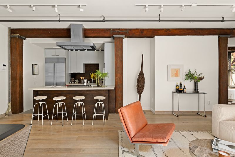 Kitchen and living space under original beams at 33 Bleecker Street 3B, NoHo — photo 3 of 9