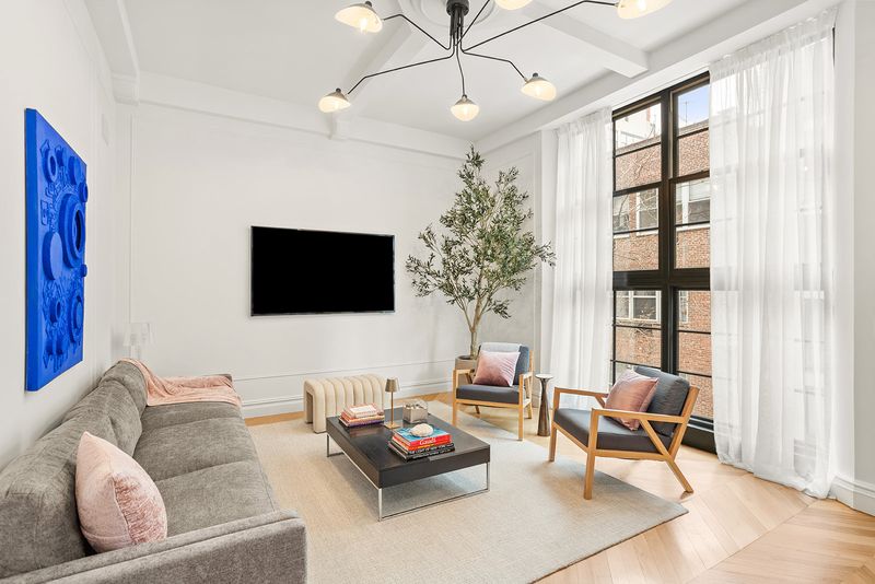 Living area under prewar windows at The Atelier, 33 West 67th Street 4M, Upper West Side — photo 2 of 8