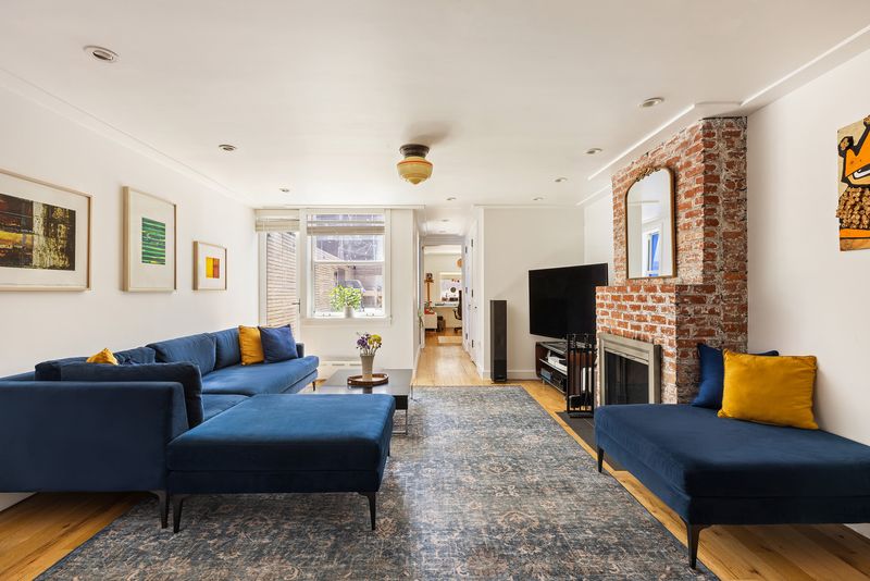 Living room with exposed brick and fireplace at 338 Metropolitan Avenue, Williamsburg