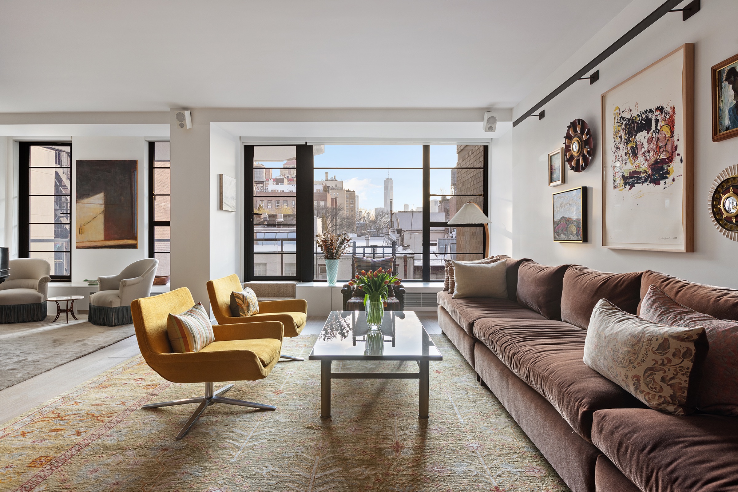 living room, yellow chairs to city windows at 37 West 12th Street 7J