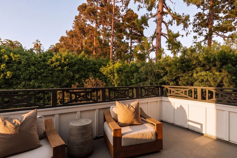 Primary balcony over the treetops at sunset at 371 20th Street, Santa Monica — photo 8 of 8