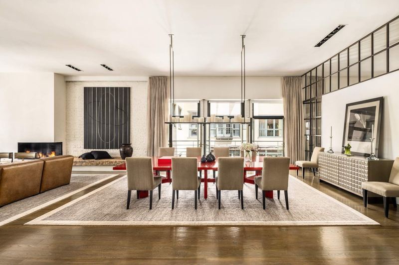 The dining area, set for 14, with windows across the Wooster Street frontage at 42 Wooster Street #3, SoHo — photo 3 of 13